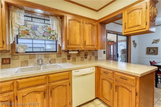 kitchen featuring dishwasher, sink, backsplash, kitchen peninsula, and crown molding