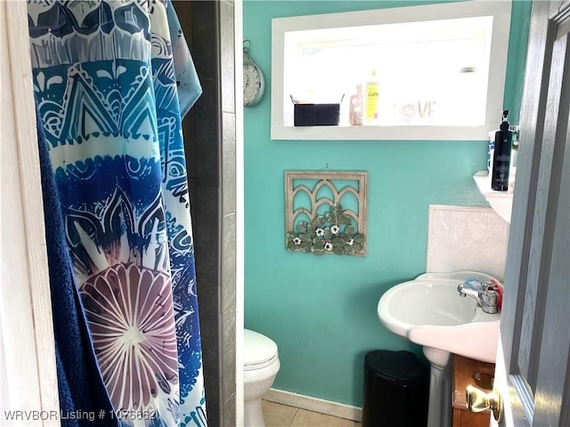 bathroom with tile patterned flooring, toilet, sink, and a shower with shower curtain