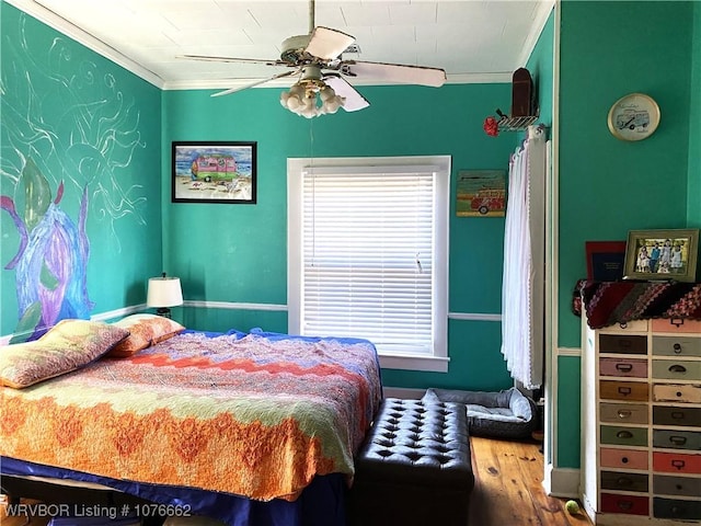 bedroom with hardwood / wood-style flooring, ceiling fan, and ornamental molding