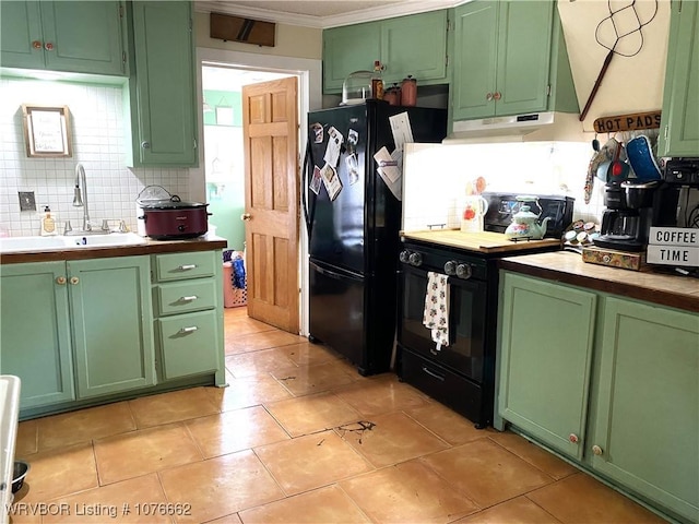 kitchen with backsplash, green cabinets, sink, and black appliances