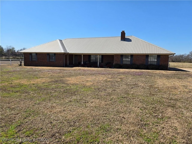 650 Paw Paw Rd, Roland, OK 74954 - view of front of home featuring a front yard, brick siding, and a chimney
