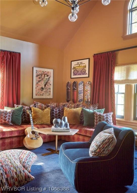 living room featuring plenty of natural light and vaulted ceiling