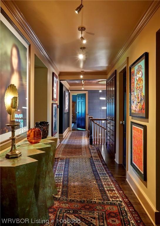 hallway with crown molding and hardwood / wood-style flooring