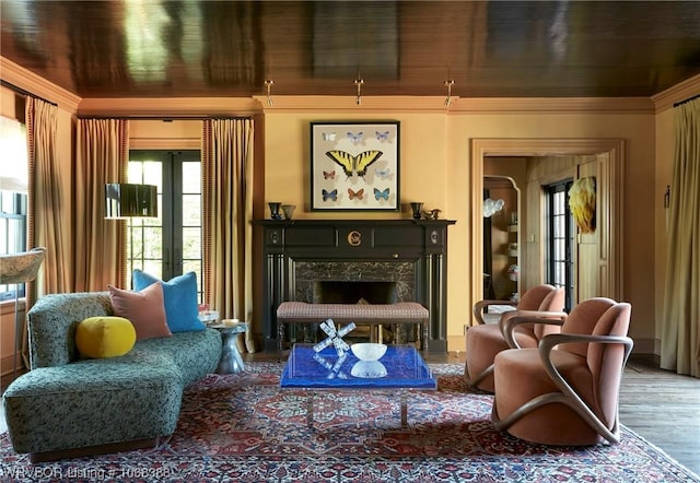 sitting room featuring hardwood / wood-style floors and a premium fireplace