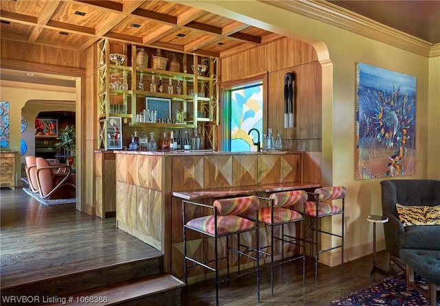 bar featuring beamed ceiling, ornamental molding, wooden ceiling, and coffered ceiling