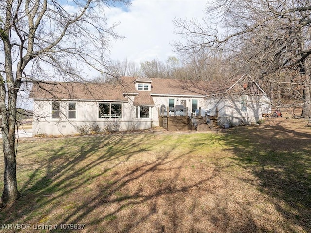 back of property with a lawn