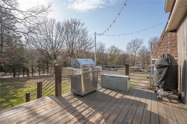 deck featuring a lawn and a grill