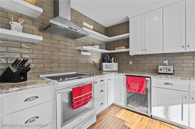 kitchen featuring wine cooler, decorative backsplash, white appliances, wall chimney exhaust hood, and open shelves