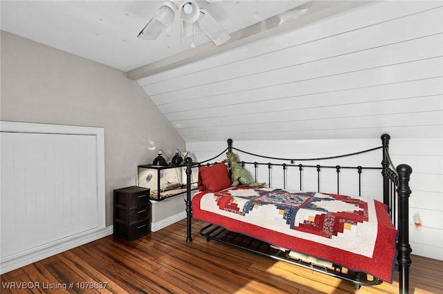 bedroom featuring lofted ceiling with beams, baseboards, wood finished floors, and a ceiling fan