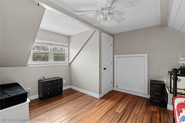 office space featuring baseboards, lofted ceiling, a ceiling fan, and wood finished floors