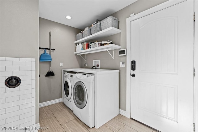 laundry area with washer and dryer, laundry area, baseboards, and wood tiled floor