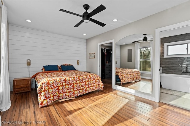 bedroom featuring a spacious closet, recessed lighting, ceiling fan, and hardwood / wood-style floors