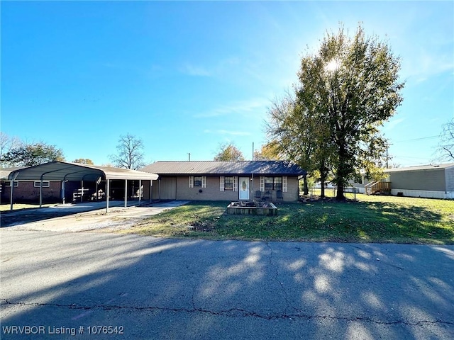 ranch-style home with a front yard and a carport