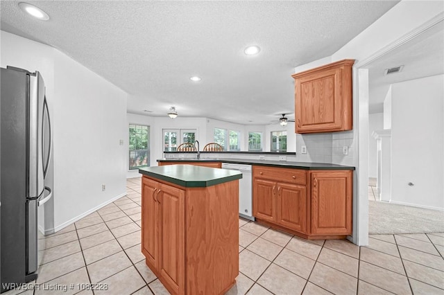 1121 Bourland St, Arkoma, OK 74901 - kitchen featuring freestanding refrigerator, white dishwasher, dark countertops, recessed lighting, and a peninsula