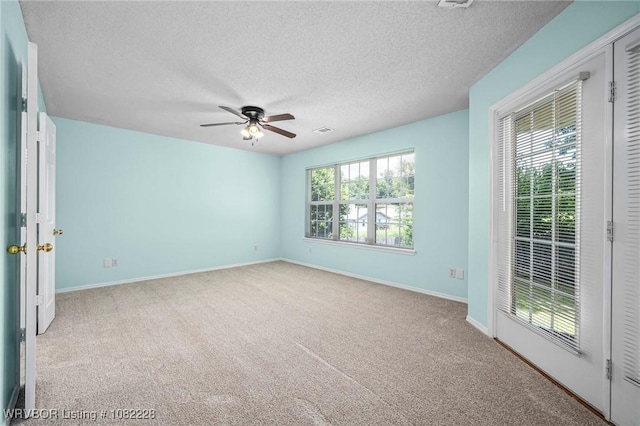 1121 Bourland St, Arkoma, OK 74901 - unfurnished room with ceiling fan, carpet, and a textured ceiling