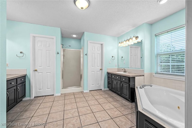 1121 Bourland St, Arkoma, OK 74901 - bathroom featuring a stall shower, a whirlpool tub, vanity, a textured ceiling, and tile patterned floors