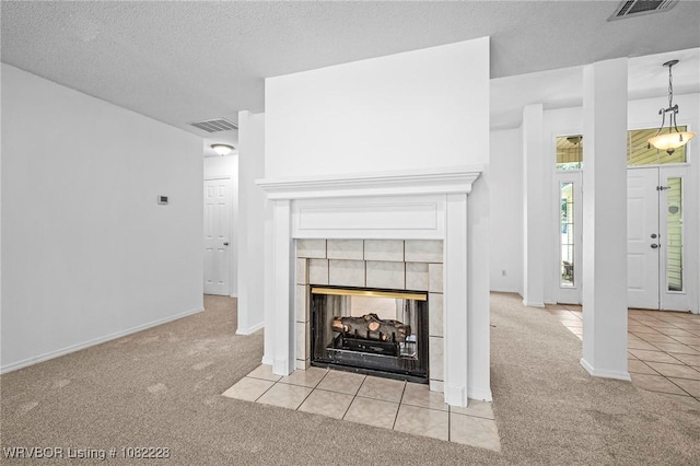 1121 Bourland St, Arkoma, OK 74901 - detailed view of carpet flooring, a textured ceiling, and a tile fireplace