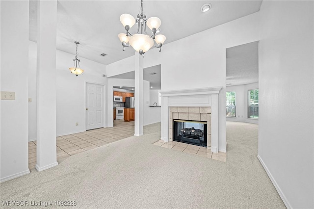 1121 Bourland St, Arkoma, OK 74901 - unfurnished living room with carpet flooring, a chandelier, a tiled fireplace, and tile patterned floors