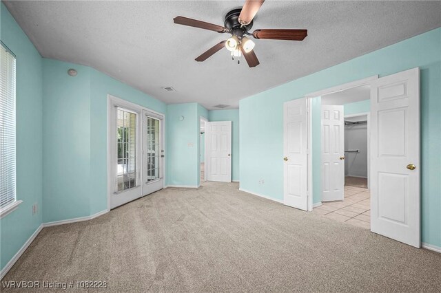 1121 Bourland St, Arkoma, OK 74901 - unfurnished bedroom featuring carpet, a textured ceiling, and a ceiling fan