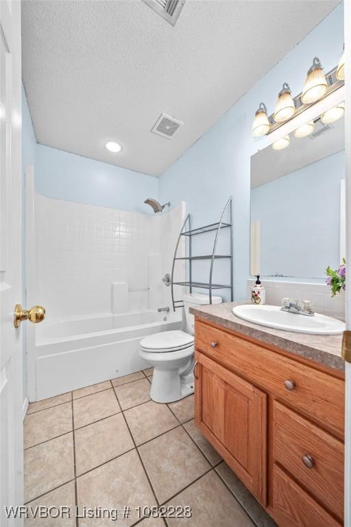 1121 Bourland St, Arkoma, OK 74901 - full bath with vanity, shower / washtub combination, tile patterned flooring, and a textured ceiling