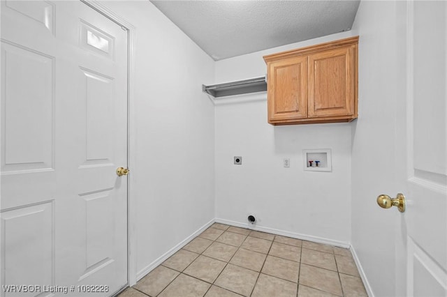 1121 Bourland St, Arkoma, OK 74901 - washroom featuring electric dryer hookup, washer hookup, cabinet space, light tile patterned flooring, and a textured ceiling