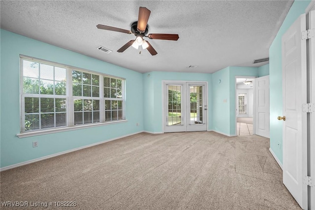 1121 Bourland St, Arkoma, OK 74901 - unfurnished room featuring a ceiling fan, carpet floors, and a textured ceiling