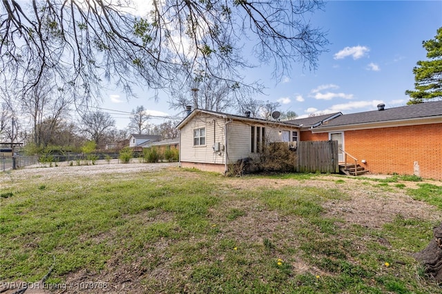 8005 Holly Ave, Fort Smith, AR 72908 - back of property featuring a yard, entry steps, brick siding, and fence