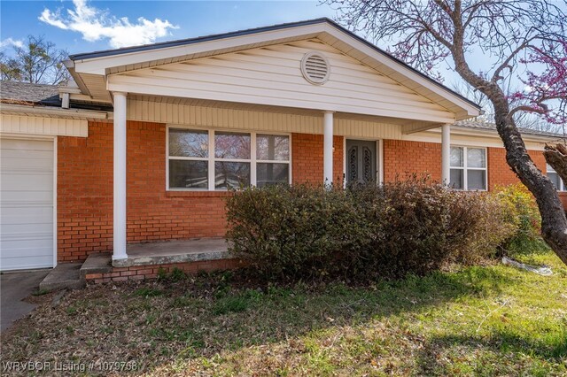 8005 Holly Ave, Fort Smith, AR 72908 - ranch-style home with brick siding, an attached garage, and a porch