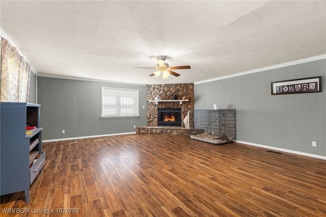 8005 Holly Ave, Fort Smith, AR 72908 - unfurnished living room featuring a stone fireplace, crown molding, a ceiling fan, and wood finished floors