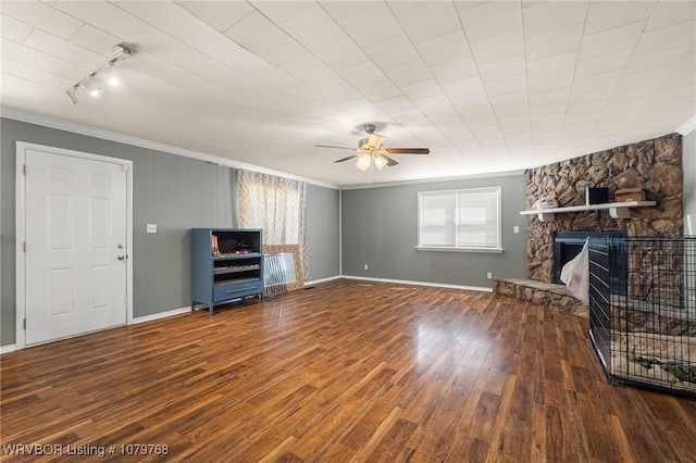 8005 Holly Ave, Fort Smith, AR 72908 - unfurnished living room featuring crown molding, baseboards, ceiling fan, hardwood / wood-style floors, and a stone fireplace
