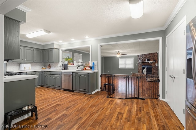 8005 Holly Ave, Fort Smith, AR 72908 - kitchen with light countertops, ornamental molding, gray cabinets, dark wood-style floors, and stainless steel appliances