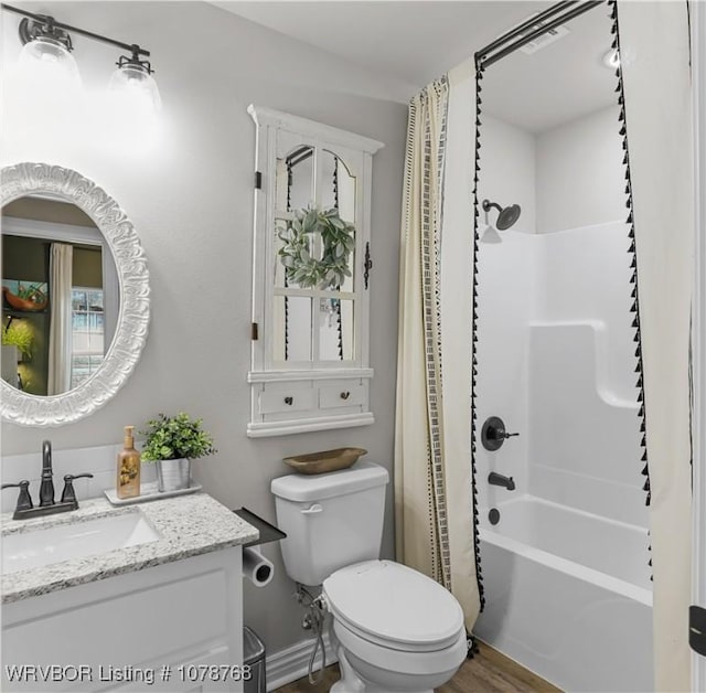 full bathroom featuring toilet, vanity, and shower / bath combo with shower curtain