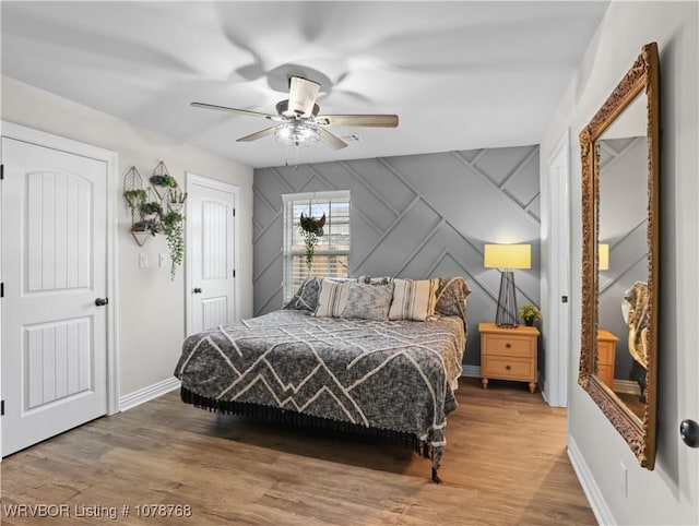 bedroom with wood-type flooring and ceiling fan