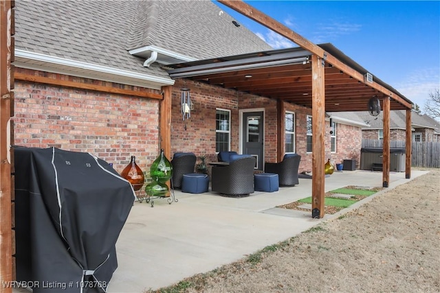 view of patio / terrace with grilling area and a hot tub