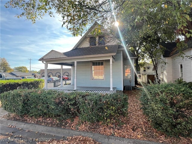 view of front of house featuring a porch and central air condition unit