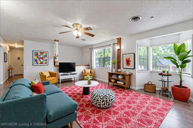 903 O St, Barling, AR 72923 - living room featuring wood finished floors, a ceiling fan, baseboards, and a textured ceiling