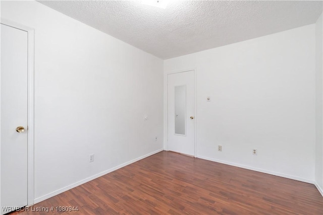 903 O St, Barling, AR 72923 - unfurnished room with wood finished floors, baseboards, and a textured ceiling
