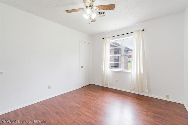 903 O St, Barling, AR 72923 - empty room with wood finished floors, ceiling fan, baseboards, and a textured ceiling