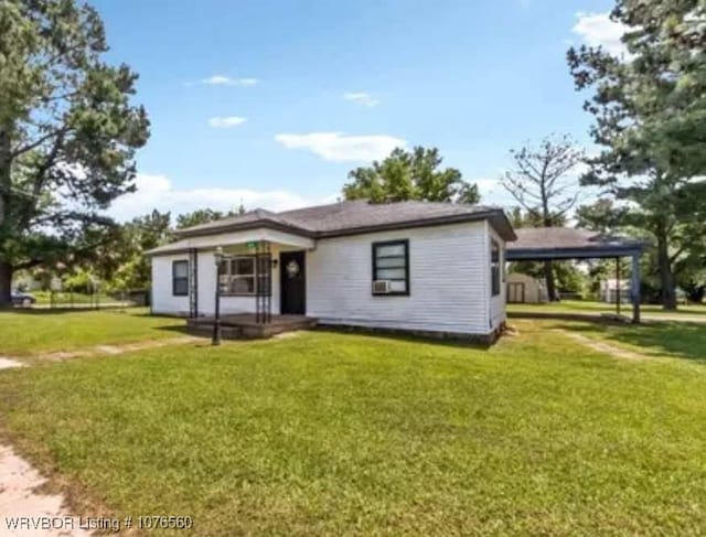 rear view of property featuring a yard