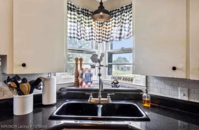 kitchen featuring sink and tasteful backsplash