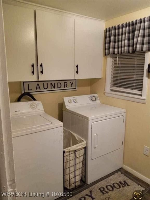 washroom with washer and dryer and cabinets