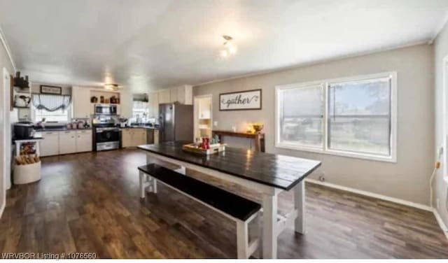 kitchen featuring crown molding, white cabinetry, dark hardwood / wood-style flooring, and stainless steel appliances