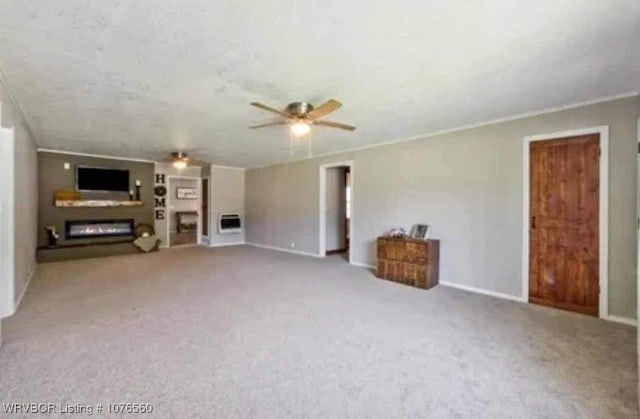 unfurnished living room featuring ceiling fan and light colored carpet