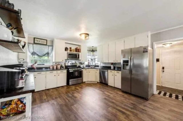 kitchen with plenty of natural light, white cabinets, and stainless steel appliances