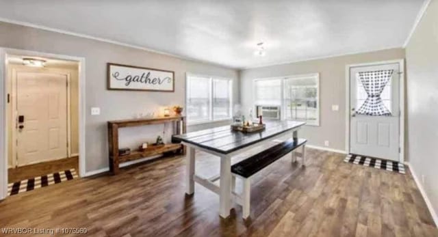 dining room with cooling unit, crown molding, and dark wood-type flooring