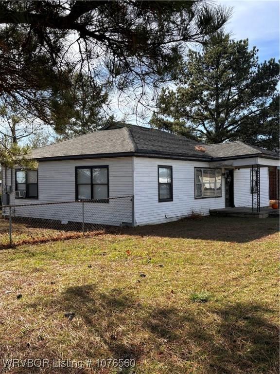 view of side of property with a yard