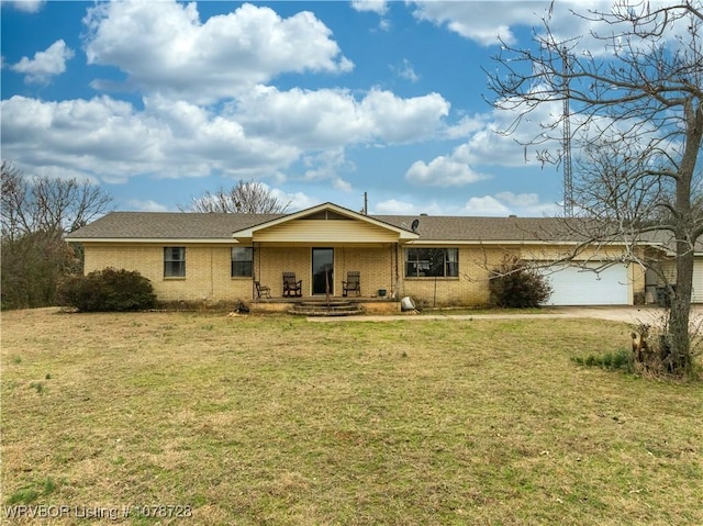 ranch-style home featuring a garage, a porch, and a front lawn