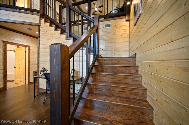 1793 Catfish Bay Rd, Broken Bow, OK 74728 - stairs with hardwood / wood-style flooring, ceiling fan, and wooden walls