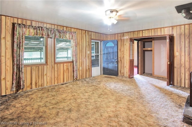 interior space with carpet flooring and ceiling fan