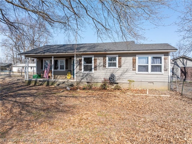 ranch-style home with covered porch, crawl space, and fence